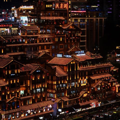 Hongyadong stilted buildings illuminated at night in Chongqing, China.